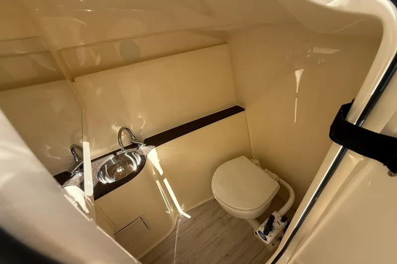 Slide: The Image of 2026 Scout 255 Dorado boat interior with sink and toilet in compact bathroom. - 33