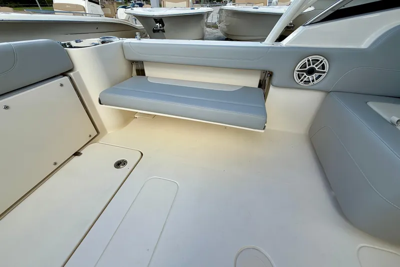 Slide: The Image of 2026 Scout 255 Dorado boat interior with gray seating and speaker detail. - 7