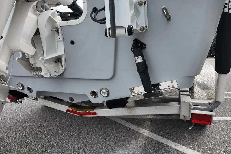 Slide: The Image of 2022 Sportsman Masters 207 Bay Boat on trailer, showing engine mount and trim tabs. - 11