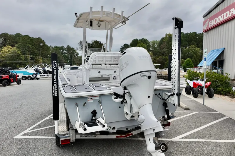 Slide: The Image of 2022 Sportsman Masters 207 Bay Boat with Yamaha engine in dealership parking lot. - 12