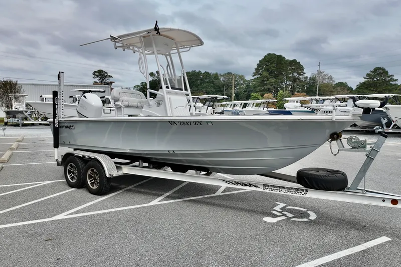 Slide: The Image of 2022 Sportsman Masters 207 Bay Boat on trailer in parking lot, overcast sky. - 13