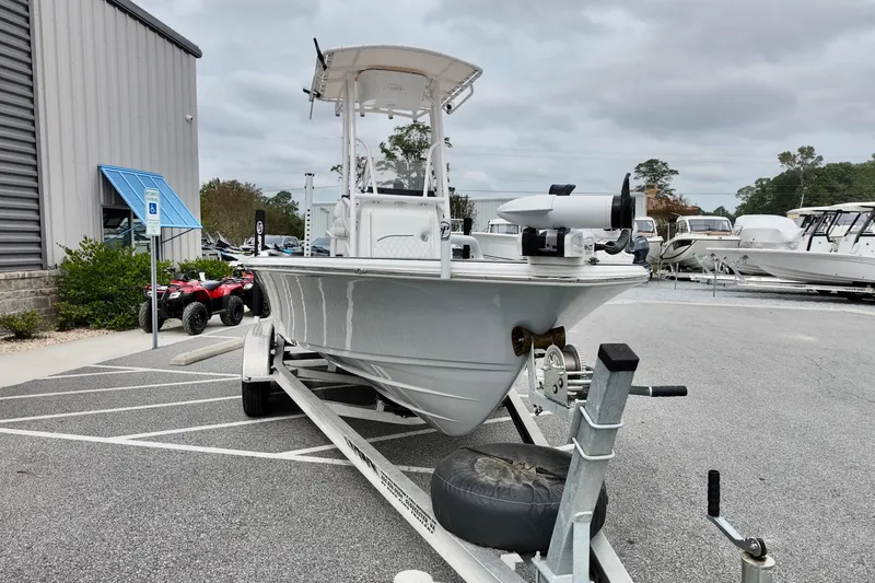 Slide: The Image of 2022 Sportsman Masters 207 Bay Boat on trailer in parking lot, overcast sky. - 14