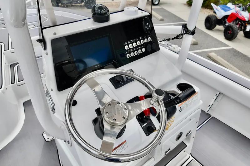 Slide: The Image of Control panel of 2022 Sportsman Masters 207 Bay Boat with steering wheel and navigation system. - 3