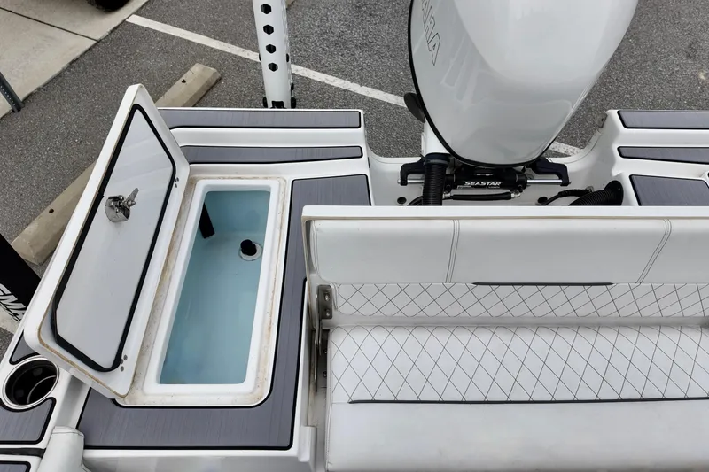 Slide: The Image of 2022 Sportsman Masters 207 Bay Boat interior with open storage compartment and seating. - 4