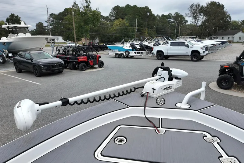 Slide: The Image of 2022 Sportsman Masters 207 Bay Boat with Minn Kota trolling motor in a dealership lot. - 9