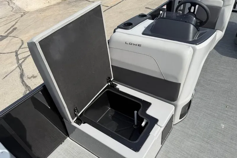 Slide: The Image of 2026 Lowe LF 214 boat interior with open storage compartment and steering console. - 13