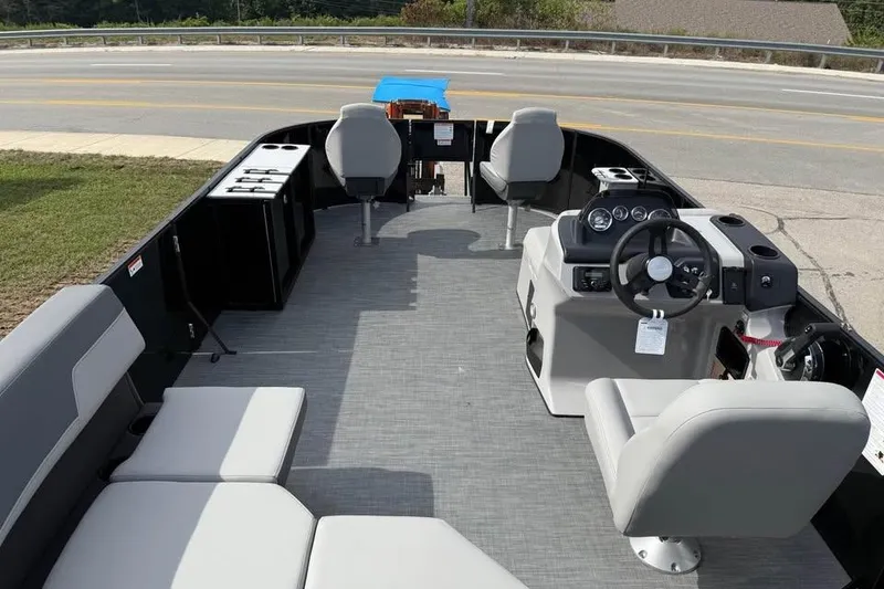 Slide: The Image of 2026 Lowe LF 214 boat interior with seating, steering console, and open deck layout. - 7