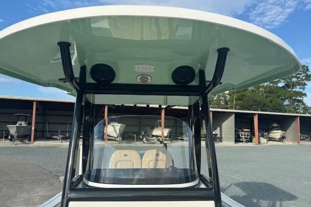 Slide: The Image of 2022 Sea Pro 239 Center Console boat with T-top and storage area in background. - 11