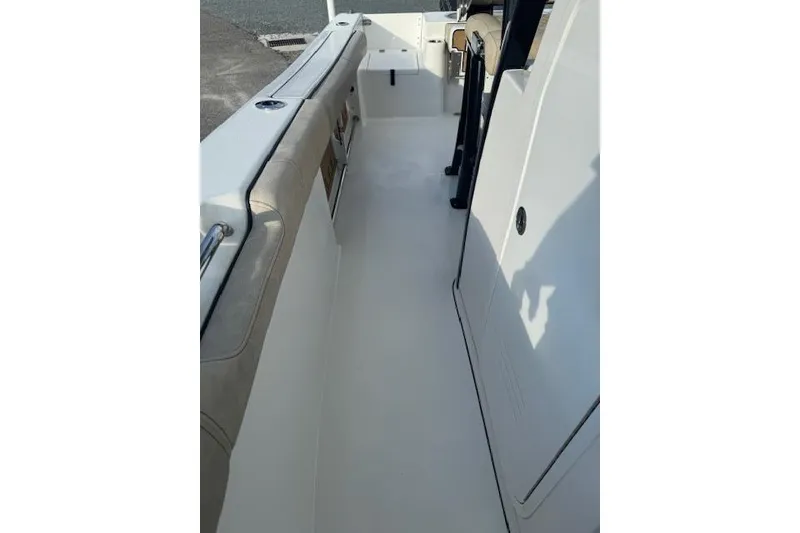 Slide: The Image of 2022 Sea Pro 239 Center Console boat interior with clean white deck and seating. - 12