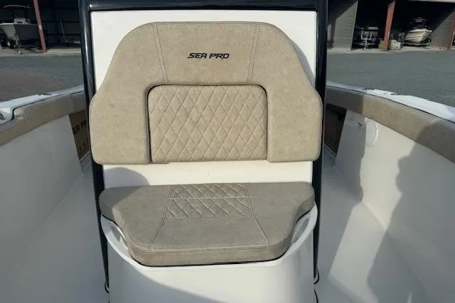 Slide: The Image of 2022 Sea Pro 239 Center Console boat seat with beige cushions and diamond stitching. - 13