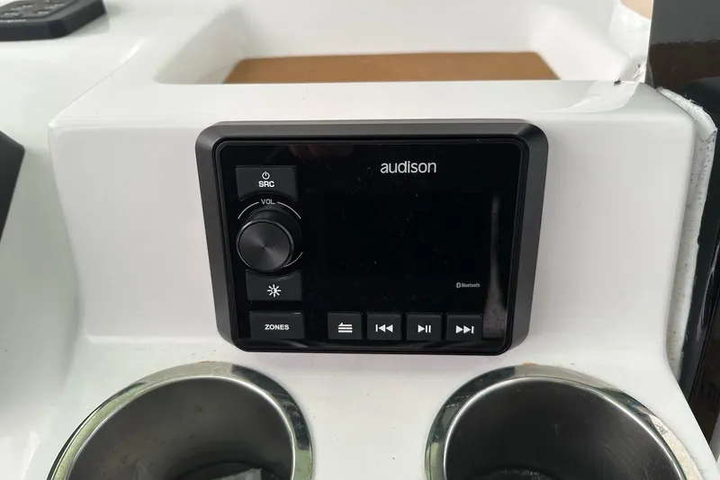 Slide: The Image of 2022 Sea Pro 239 Center Console audio control panel with cup holders. - 18