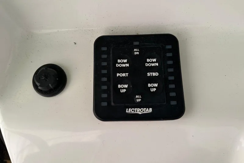 Slide: The Image of Control panel of a 2022 Sea Pro 239 Center Console boat with Lectrotab system. - 19