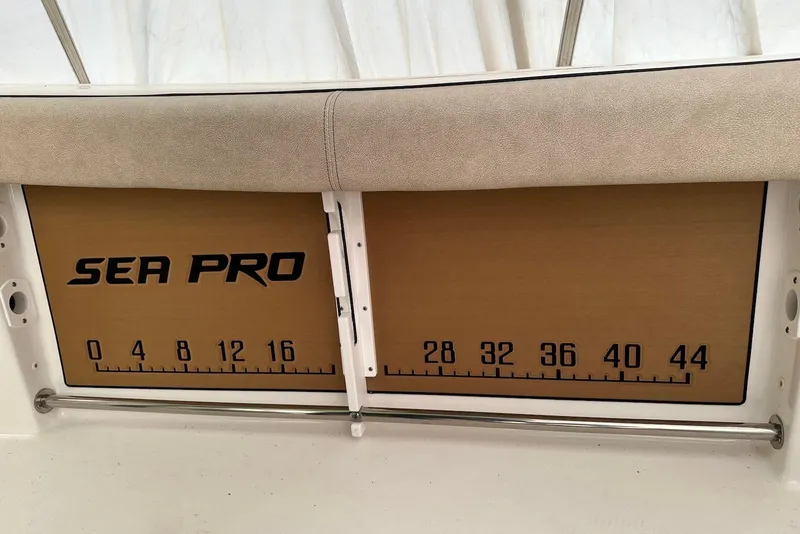 Slide: The Image of 2022 Sea Pro 239 Center Console boat with measuring board and cushioned seat. - 20