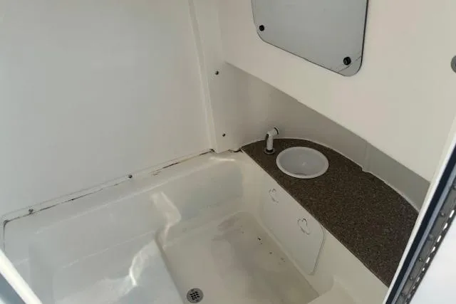 Slide: The Image of 2022 Sea Pro 239 Center Console interior with sink and storage area. - 22