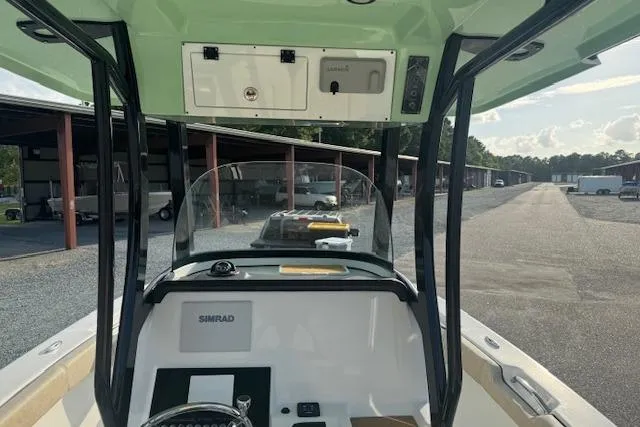 Slide: The Image of 2022 Sea Pro 239 Center Console boat interior with steering and navigation equipment. - 7