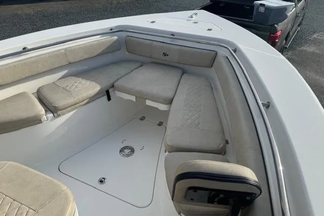 Slide: The Image of 2022 Sea Pro 239 Center Console boat with beige cushioned seating. - 8