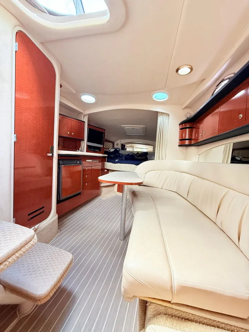 Slide: The Image of Interior of 2004 Sea Ray 300 Sundancer yacht with elegant seating and kitchenette. - 10