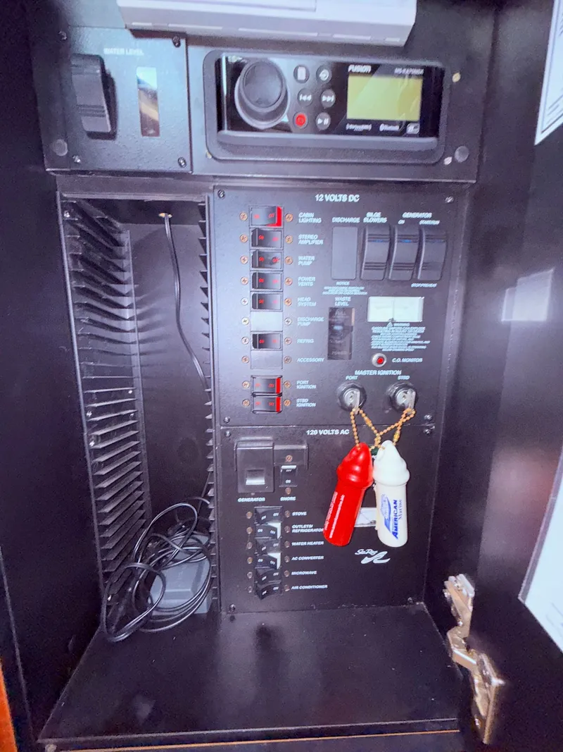 Slide: The Image of Electrical panel of a 2004 Sea Ray 300 Sundancer boat with switches and controls. - 14