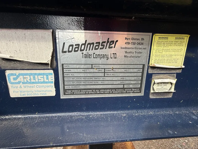 Slide: The Image of Trailer information plate for Loadmaster, 2004 Sea Ray 300 Sundancer, with safety and warranty details. - 15