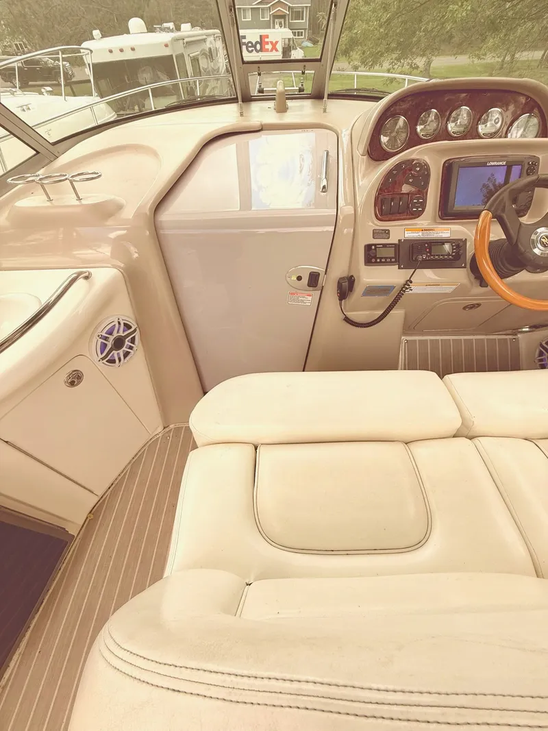 Slide: The Image of Interior view of 2004 Sea Ray 300 Sundancer boat cockpit with steering and controls. - 6