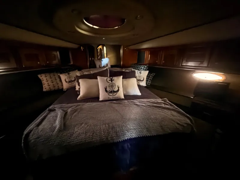 Slide: The Image of Luxurious cabin interior of 2006 Cruisers Yachts 560 Express with cozy bedding and ambient lighting. - 17