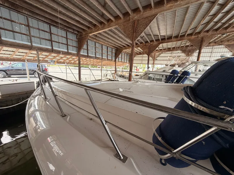 Slide: The Image of 2006 Cruisers Yachts 560 Express docked in a covered marina. - 21