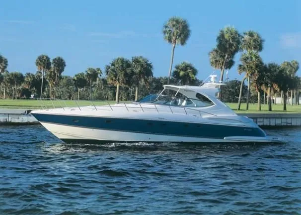 Slide: The Image of 2006 Cruisers Yachts 560 Express on water, palm trees in background. - 22