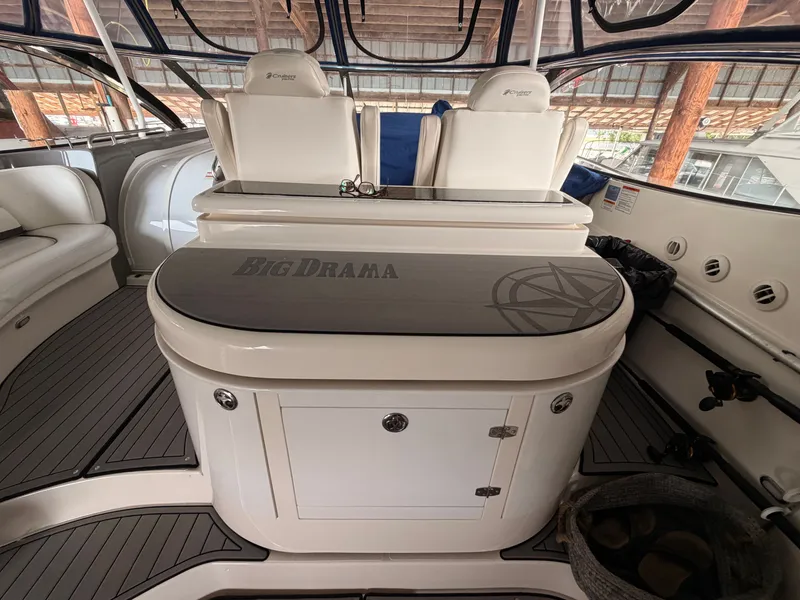 Slide: The Image of 2006 Cruisers Yachts 560 Express interior with "Big Drama" table, luxury seating, and sleek design. - 8
