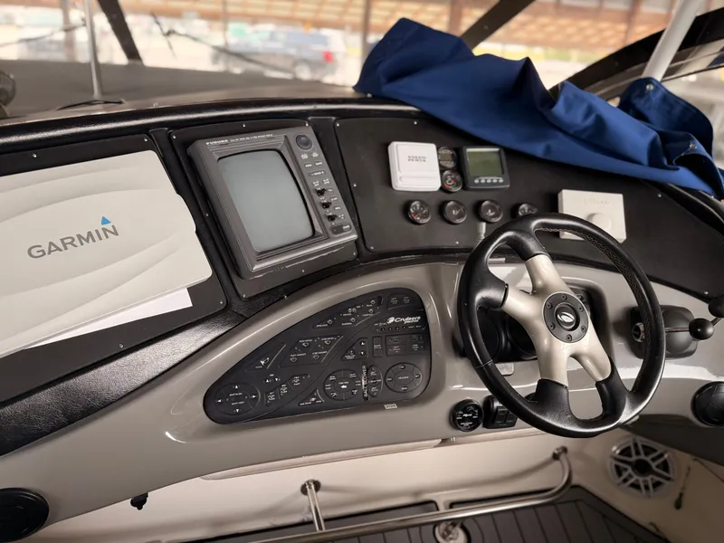 Slide: The Image of 2006 Cruisers Yachts 560 Express helm with Garmin navigation and steering wheel. - 20