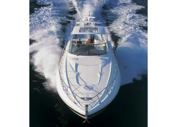 Slide: The Image of 2006 Cruisers Yachts 560 Express cruising on open water, aerial view. - 23