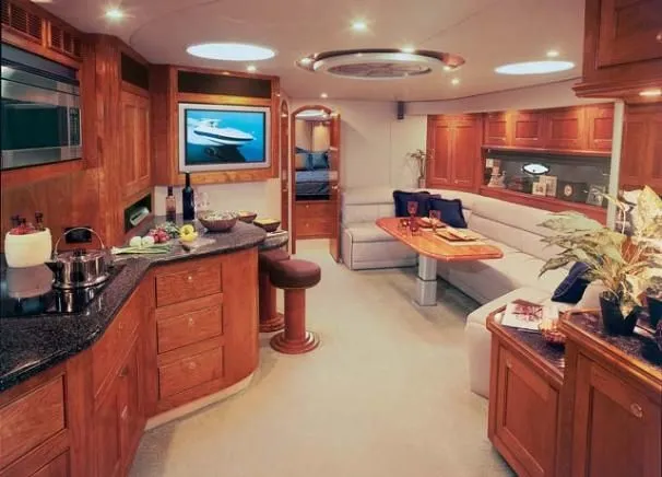 Slide: The Image of Luxurious interior of 2006 Cruisers Yachts 560 Express with modern kitchen and cozy seating area. - 25