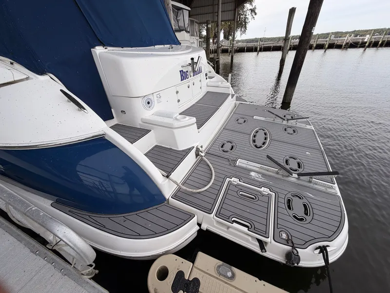 Slide: The Image of 2006 Cruisers Yachts 560 Express docked, featuring spacious swim platform and sleek design. - 3