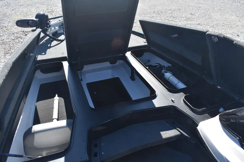 Slide: The Image of 2023 Skeeter ZXR20 boat storage compartments with open lids and visible equipment. - 12