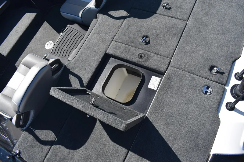 Slide: The Image of 2023 Skeeter ZXR20 boat interior with open storage compartment and seating. - 18