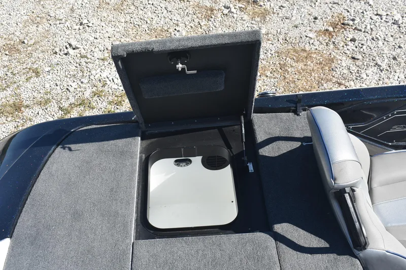 Slide: The Image of 2023 Skeeter ZXR20 boat storage compartment with open lid, showing interior details. - 19
