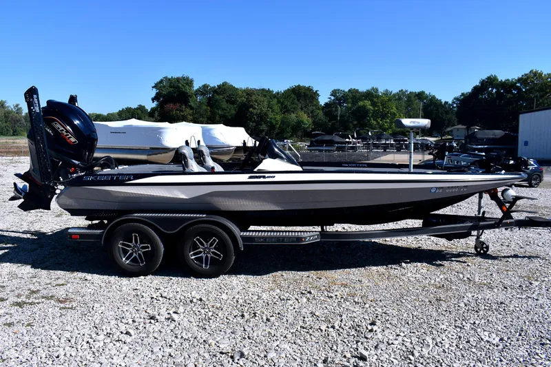 Slide: The Image of 2023 Skeeter ZXR20 boat on trailer, parked outdoors on gravel. - 5