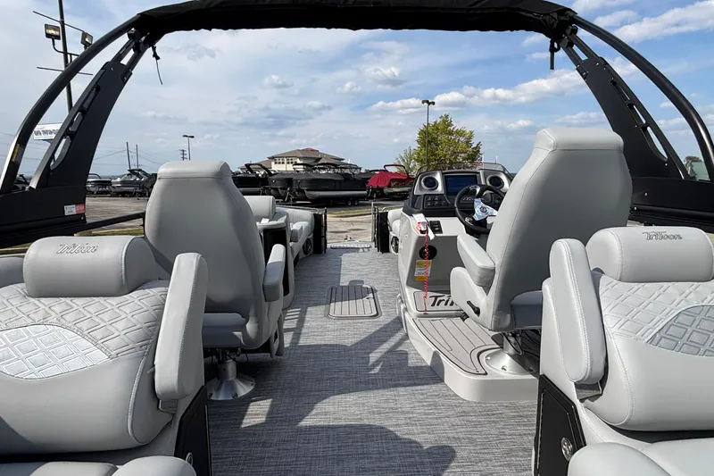 Slide: The Image of 2026 JC Sporttoon 26TT boat interior with luxurious seating and modern dashboard. - 14