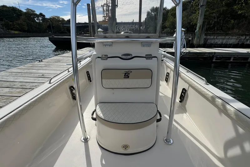 Slide: The Image of 2021 Carolina Skiff 21 LS boat interior at dock, featuring seating and console. - 12