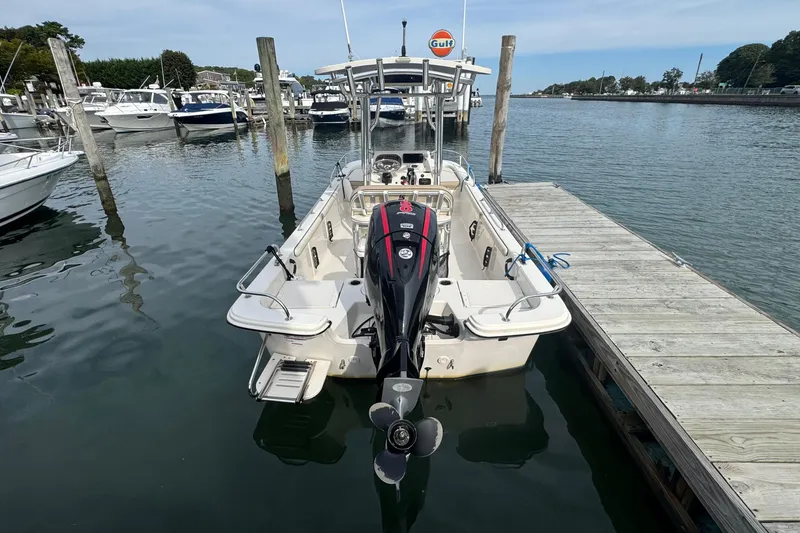 Slide: The Image of 2021 Carolina Skiff 21 LS boat docked at marina, rear view. - 2