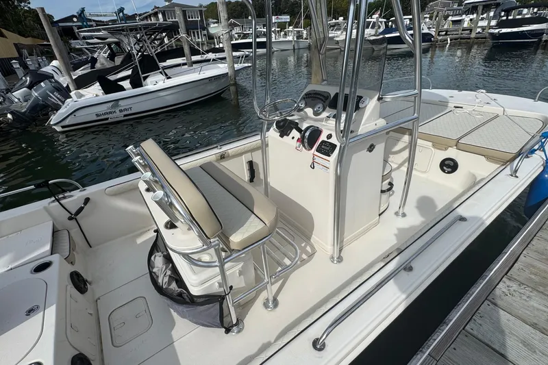 Slide: The Image of 2021 Carolina Skiff 21 LS boat interior at marina, featuring console and seating. - 7