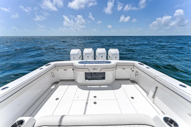 Slide: The Image of 2021 Valhalla Boatworks V-41 on open sea, showcasing spacious deck and quad engines. - 19