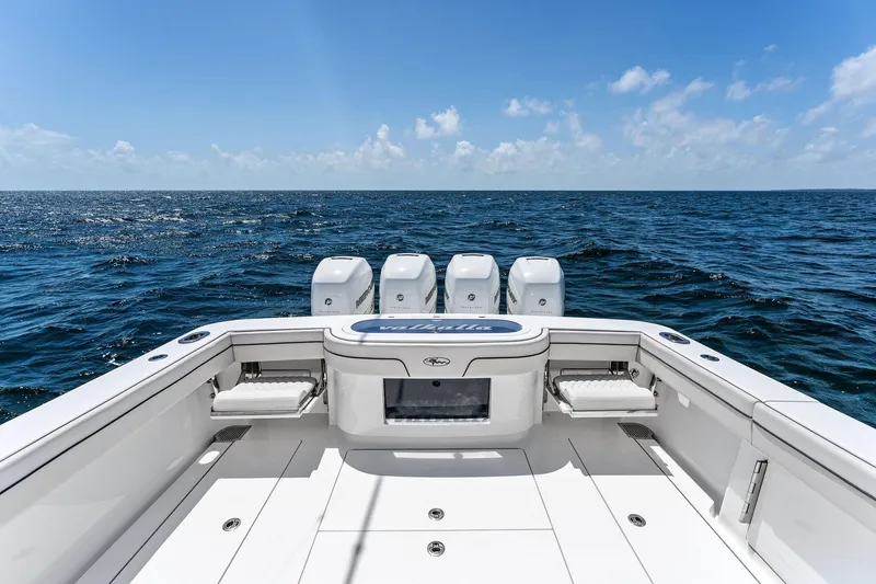 Slide: The Image of 2021 Valhalla Boatworks V-41 on open sea, showcasing spacious deck and powerful engines. - 21