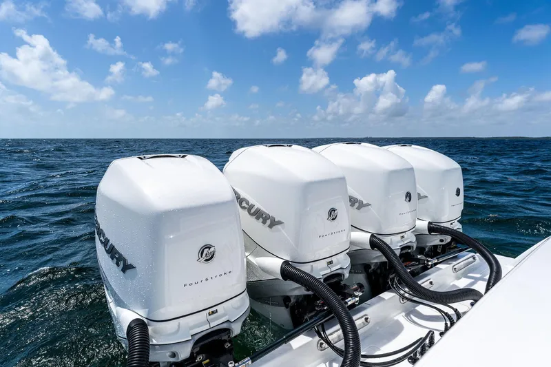 Slide: The Image of Four Mercury outboard engines on a 2021 Valhalla Boatworks V-41, cruising on open water. - 26