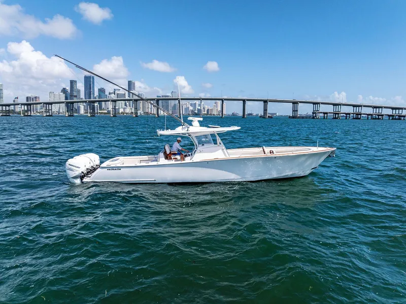 Slide: The Image of 2021 Valhalla Boatworks V-41 cruising on blue water with city skyline backdrop. - 3