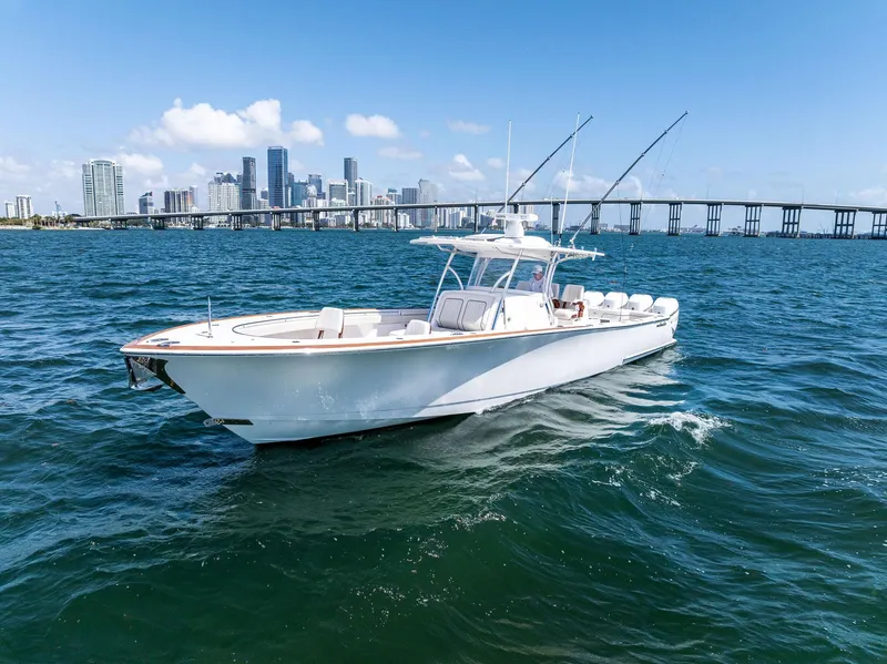 Slide: The Image of 2021 Valhalla Boatworks V-41 cruising on blue waters near a city skyline and bridge. - 6