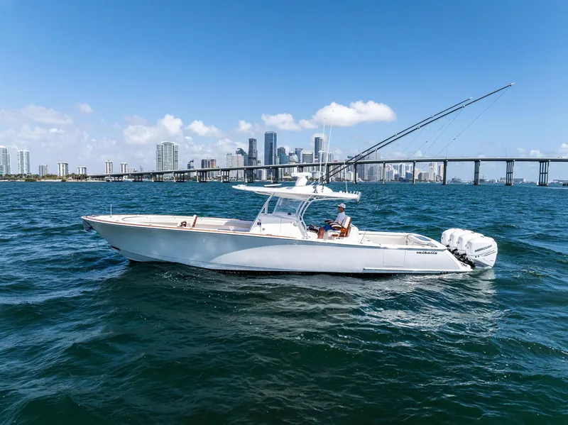 Slide: The Image of 2021 Valhalla Boatworks V-41 cruising on blue water with city skyline backdrop. - 7