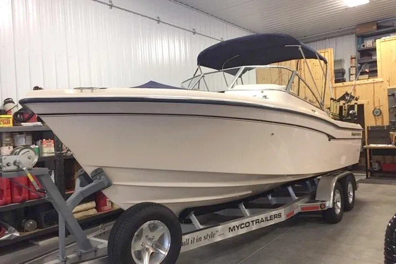 The Image of 2007 Grady-White Tournament 225 boat on trailer in garage setting. - 0