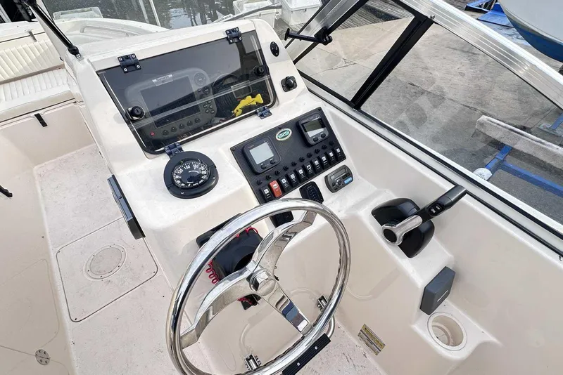 Slide: The Image of 2007 Grady-White Tournament 225 boat dashboard with steering wheel and control panel. - 20