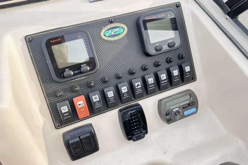 Slide: The Image of Dashboard of 2007 Grady-White Tournament 225 boat with control panels and switches. - 21