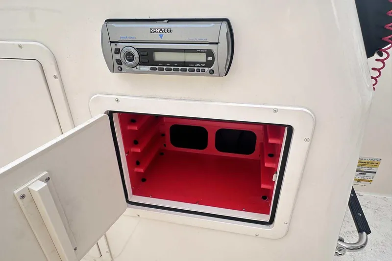Slide: The Image of 2007 Grady-White Tournament 225 boat with Kenwood stereo and open storage compartment. - 28